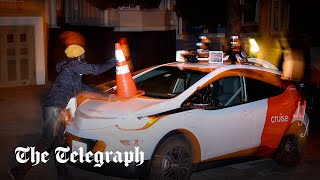 video: Watch: Protesters disable self-driving taxis with traffic cones