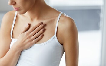 Closeup Of Young Woman Feeling Strong Pain In Chest