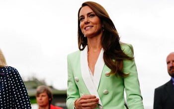 The Princess echoed the umpire look in a mint and cream Balmain jacket