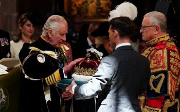 King Charles is presented with the Crown of Scotland during the service of thanksgiving and dedication at St Giles' Cathedral
