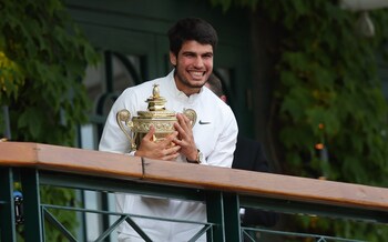 Carlos Alcaraz shows off his trophy