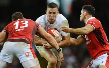 England's Freddie Steward is tackled by Wales's George North and Tomos Williams during the hosts' victory in Cardiff
